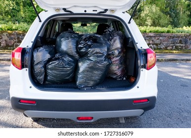 Black Plastic Bin Bags Full Tied And In Car Boot With Door Open For Fly Tipping