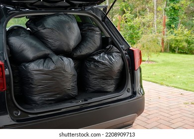 Black Plastic Bin Bags Full Tied And In Car Boot With Door Open For Fly Tipping