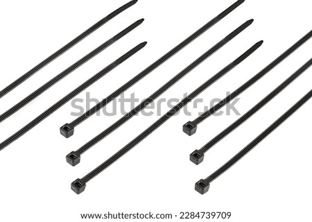 Black plastic cable ties isolated on white background. plastic wire ties close-up.