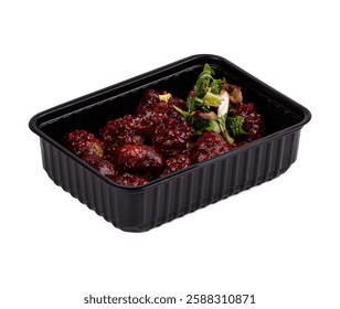 A black plastic container that is completely filled with a delicious assortment of meat and fresh vegetables resting on a clean white background