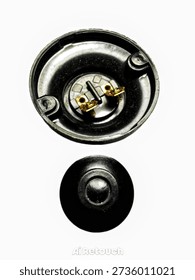Black plastic electrical fitting isolated on white background. Industrial electrical connector or lamp holder component made of durable insulating plastic. Used for electrical installation, lighting fixture assembly, and wiring accessories. Simple cylindrical design with flange for stable mounting. Suitable for household and industrial electrical applications.