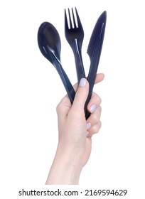 Black Plastic Fork, Knife, Spoon In Hand On White Background Isolation