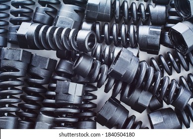 Black Plastic And Rubber Parts Of Automotive Manufacturing By High Precision Mold Injection In The Industrial Factory. Spare Part Background Texture.