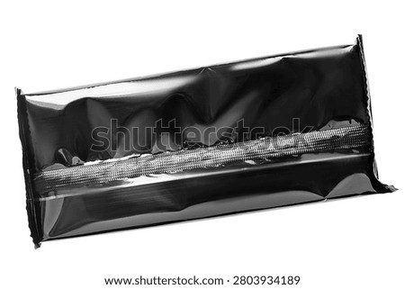 Black plastic unopened package isolated on white background