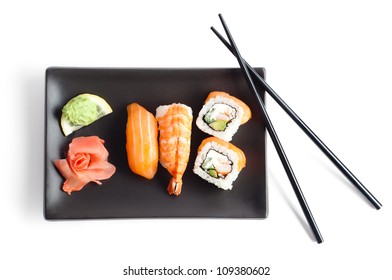 Black Plate With Sushi And Chopsticks, Isolated