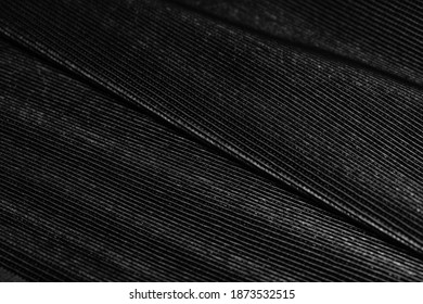 Black Pleated Leather Lining Folded On A Wooden Table