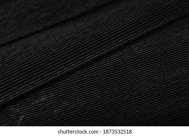 Black Pleated Leather Lining Folded On A Wooden Table