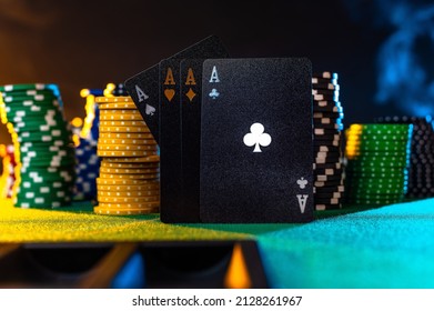 Black Poker Cards And Multi-colored Chips On A Green Gambling Table. Brown Background. Close-up. No People. Casino, Nightclub, Poker, Gambling, Gambling, Nightlife.