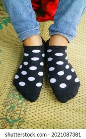 Black Polka Dot Socks Worn On Someone's Feet Photo