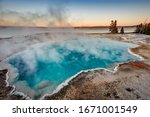 Black Pool at West Thumb Geyser Basin Trail during wonderful colorful sunset, Yellowstone National Park, Wyoming, USA