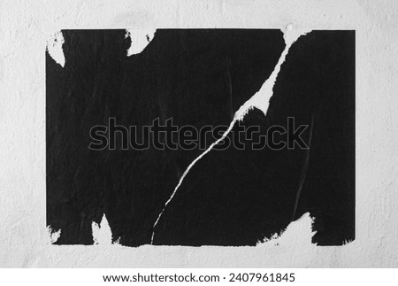 Black poster with cracks close-up.