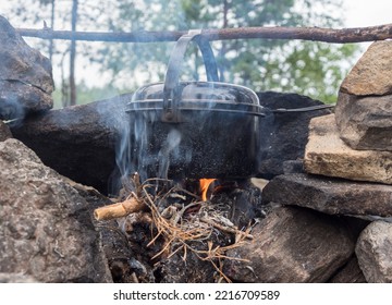 Black Pot Over A Fire In A Stone Hearth