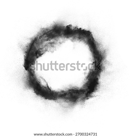 Black powder exploding in a circular frame shape isolated on white. as an abstract overlay, border, background, or element for dynamic concepts.