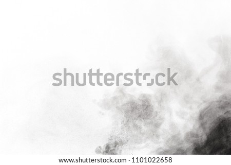 
Black powder explosion. Closeup of black dust particles explode isolated on white background