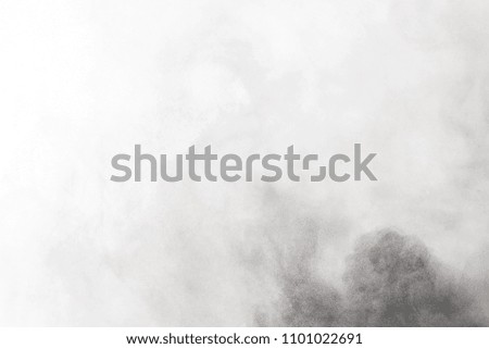 
Black powder explosion. Closeup of black dust particles explode isolated on white background
