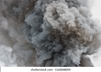 Black powder explosion.Colored cloud.Black dust explode.Paint Holi.Bomb smoke background,Smoke caused by explosions