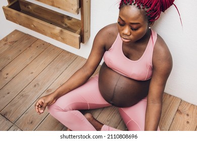 Black pregnant woman doing some ioga and meditation