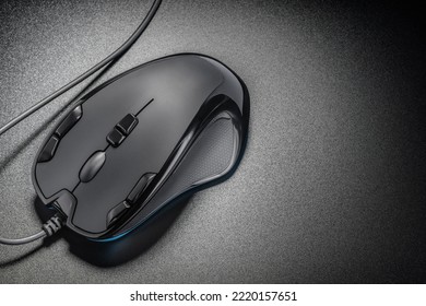 Black professional gaming wired gaming mouse on a simple black background