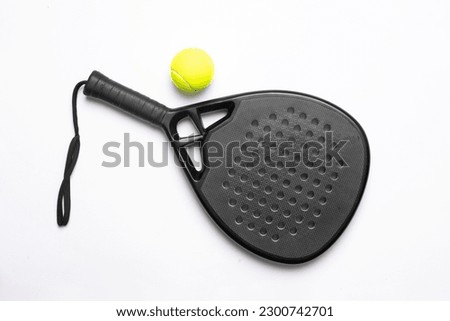 Black professional paddle tennis racket and ball on white background. Horizontal sport theme poster, greeting cards, headers, website and app