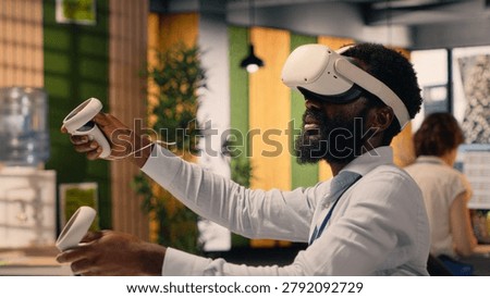 Black professional using VR glasses in corporate office environment, high-tech virtual reality applications display charts and performance metrics, combining metaverse simulation and data analysis.