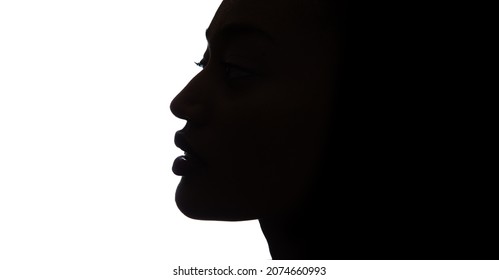 Black profile of an African woman on a white background, shaded silhouette of head. Proud woman face.