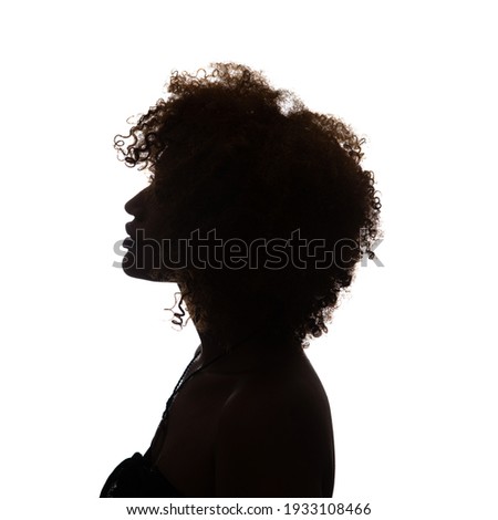 Black profile of an African woman on a white background, shaded silhouette, head and shoulders.