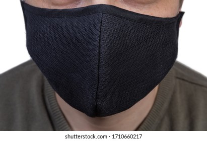 Black Protective Fabric Mask Wearing On A Face Close-up In Selective Focus
