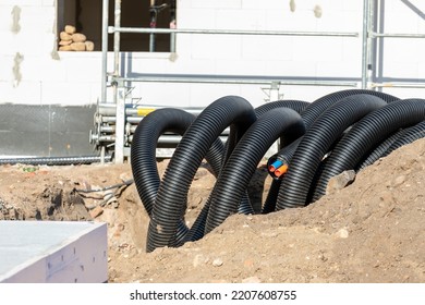 Black PVC Flexible Corrugated Plastic Insulation Pipes Tubing Of Electrical Cables Wire At Undeground Installation. New Modern Building Construction Site With Engineering Pipeline Drainage Technology