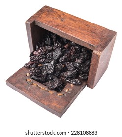 Black Raisin In A Wooden Box Over White Background