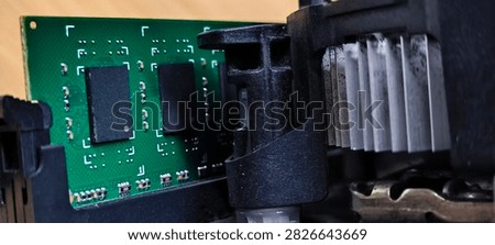 The black RAM memory chips are mounted on a green printed circuit board.