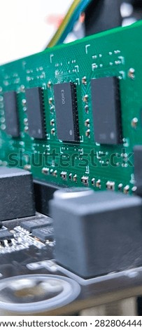 The black RAM memory chips are mounted on a green printed circuit board.