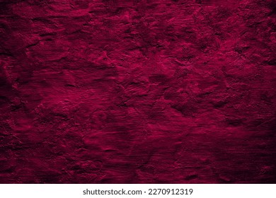 Black raspberry red rough painted surface. Toned old wall. Viva magenta color. Trend 2023. Close-up. Dark colorful grunge texture background for design. Brush strokes. Distressed, dirty, grain.