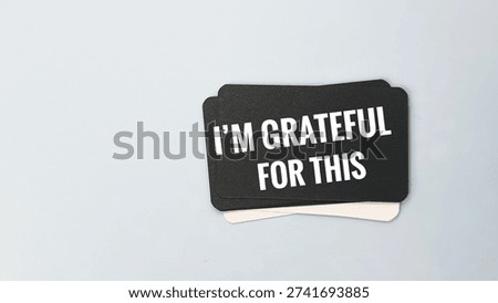 Black rectangular card with I'M GRATEFUL FOR THIS white text, sincere gratitude message concept expressing appreciation, recognition, and heartfelt thanks. 