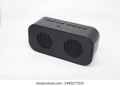 Black rectangular speaker with two circular speakers and buttons. Ideal for tech or musicthemed designs, audiorelated projects, and advertisements.