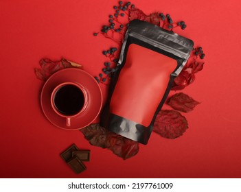 Black Red Coffee Packaging Mockup And Coffee Beans On Red Background. Top View Coffee Packaging Concept Mockup. Red Coffee Mock-up.