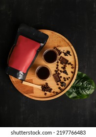 Black Red Coffee Packaging Mockup With Chocolate And Coffee Beans Next To 2 Cups Espresso Shot On Wooden Tray On Black Background. Coffee Package Mockup