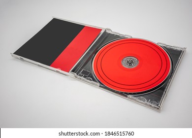 Black and red compact disc, CD, with plastic case isolated on white background. Template