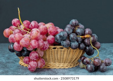 Black and red grapes in a wicker basket on a table. - Powered by Shutterstock