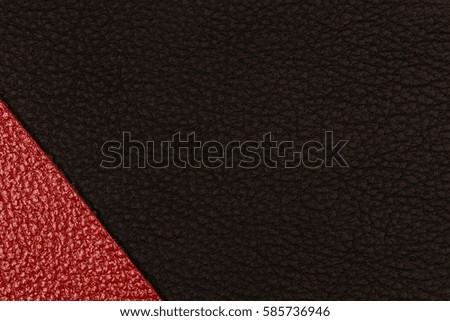 Black and red natural leather texture closeup. Top view