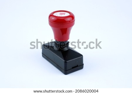 Black and red plastic stamp white isolated background.