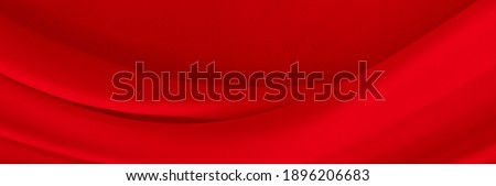 Black red satin dark fabric texture luxurious shiny that is abstract silk cloth background with patterns soft waves blur beautiful.