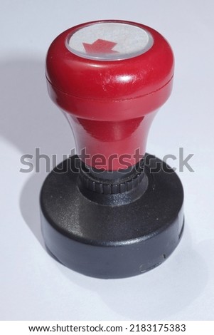 black red stamp made of plastic on a white background