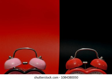 Black and red table clocks on the black and red background. Time concept. - Shutterstock ID 1084380050