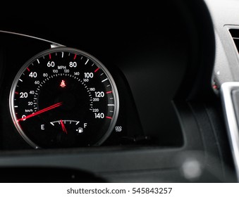 Black, red and white car dashboard and speedometer