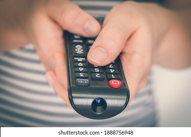 Black Remote Control In Female Hands Pointing To TV - Retro Style