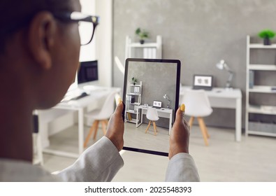 Black Rental Agent Takes Photo Of Apartment Interior Using Smart Tablet. Realtor Video Calling Client, Showing Office Workspace, Giving Tour Around New Home. Over Shoulder Device Display Close Up View