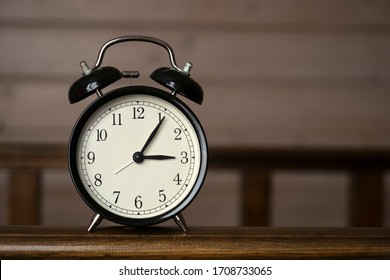 Black retro alarm clock on the table