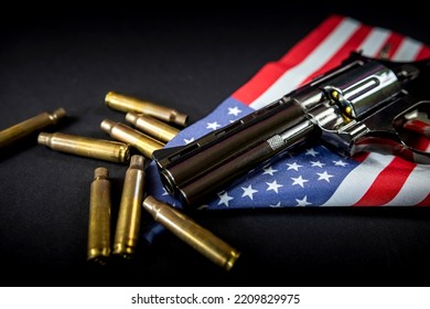 Black Revolver And Ammunition On The Folded United States Flag Is Against The Constitution Of The United States. Violence. Banning The Sale Of Illegal Weapons.