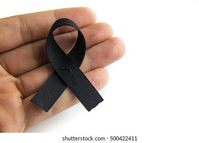 Black Ribbon On Human Hand With White Background Symbolic Icon For Remembrance/ Mourning Over People's Death: RIP Pray For Peace