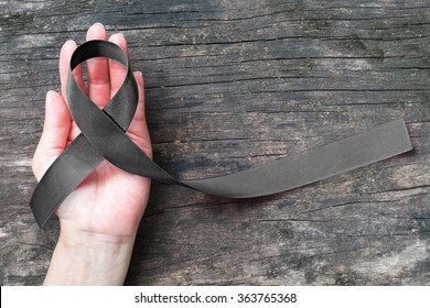 Black Ribbon Symbol Raising Public Awareness On Melanoma And Skin Cancer Prevention, Mourning For The Death Loss Of Victims And Terror Attack Concept